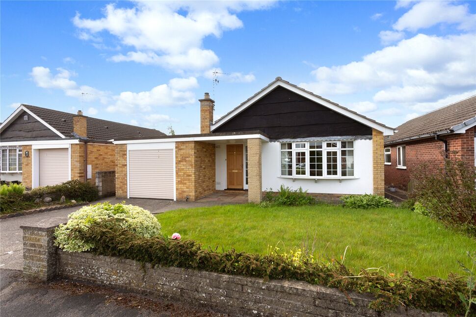 Modern UK home with neat front garden and “For Sale” sign
